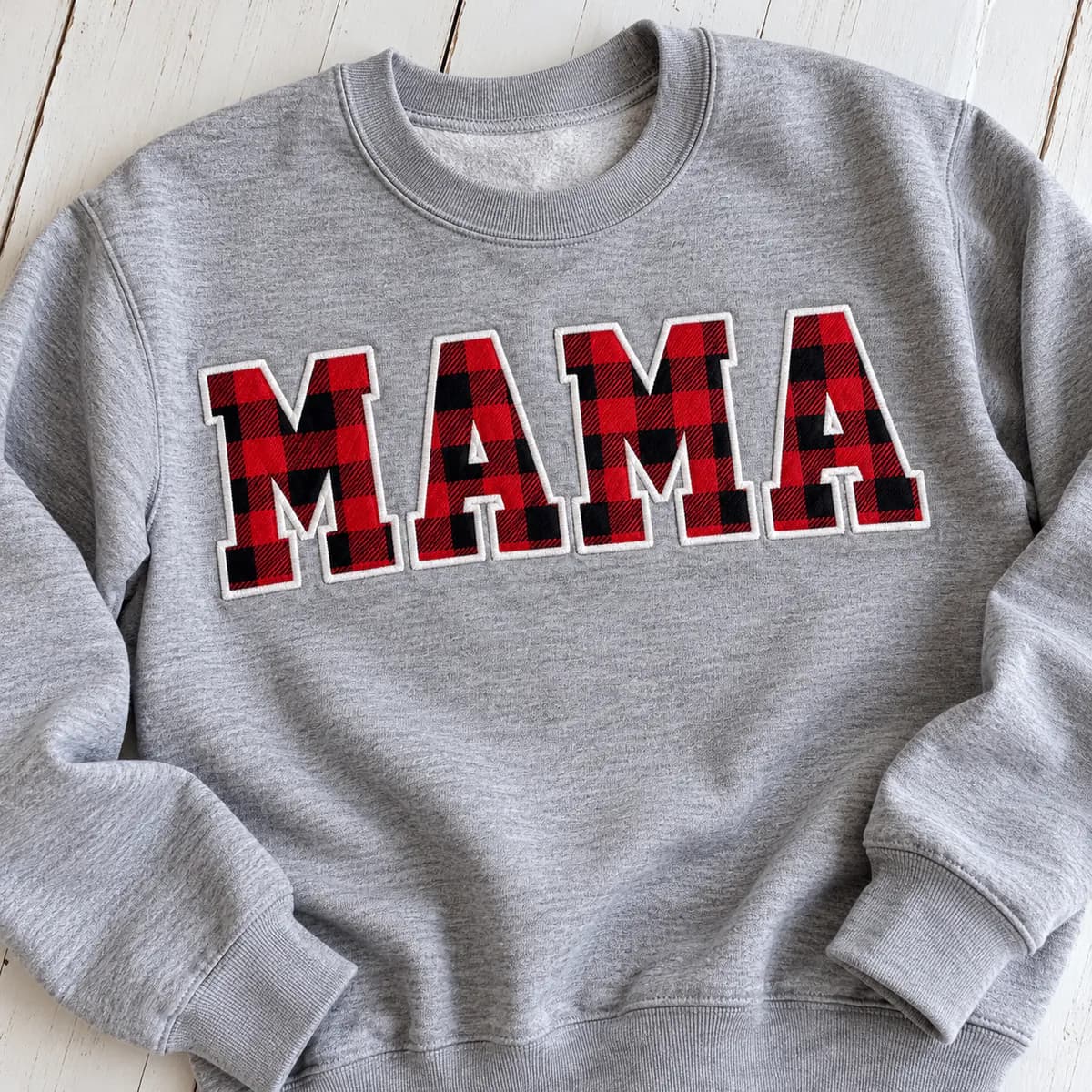 Applique embroidery letters on a sweatshirt